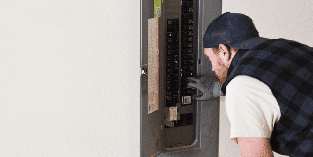 Electrician updating a panel and installing new breakers for a dedicated circuit